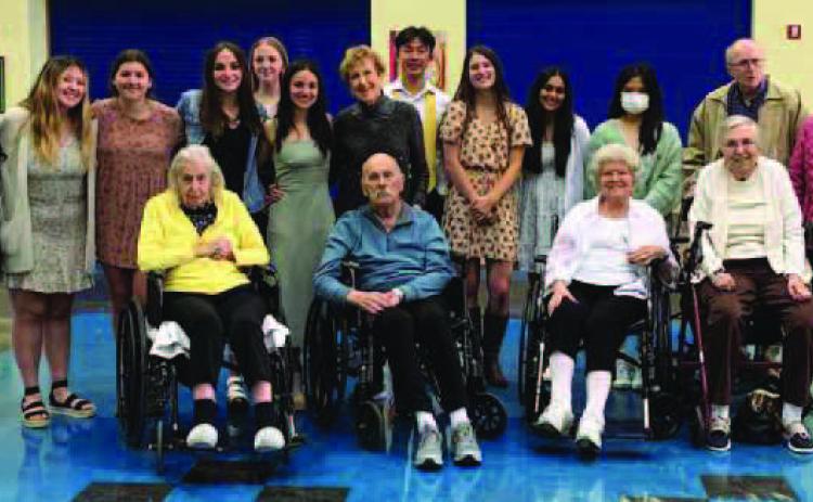 Guests enjoy dinner and dancing with Perrysburg High School students at a previous Senior Citizen Prom.