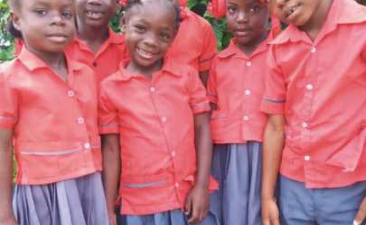 These children have benefited in many ways from Missions International of America. Below, the Brad Reddick School in Savanette-Sud, Haiti, was built by local Haitians with funds donated by MIA.