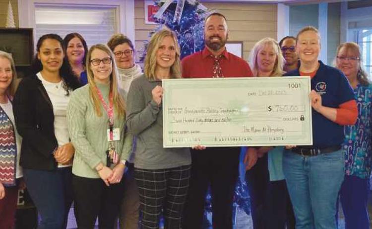 The Manor at Perrysburg, 250 Manor Drive, recently held a silent wreath auction and gala at the end of November. The event raised $760 and benefitted a local program with Wood County Educational Service Center–Grandparents Raising Grandchildren program. Pictured holding the check are Sarah and Angie from WCESC and the leadership team from the Manor at Perrysburg.