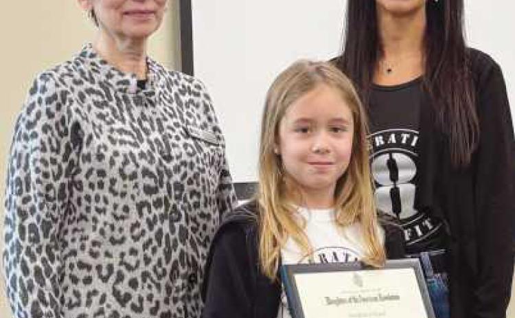 Paula Lauer, treasurer of Fort Industry Chapter, presents award to Nikki Hernandez.