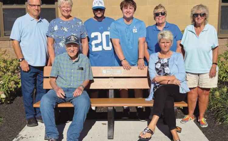 The McMorgan family at Municipal Park, pictured with the bench they donated to the city in honor of Jim.