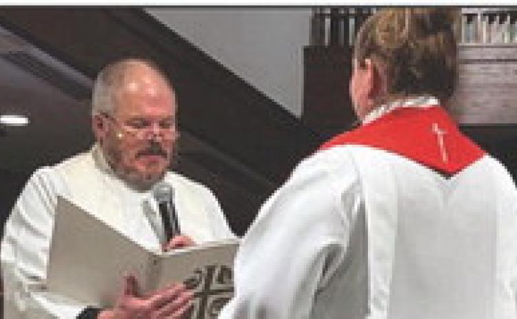 Rev. Paul Reichert, senior pastor of Zoar, participates in the ordination ceremony for the new associate pastor.