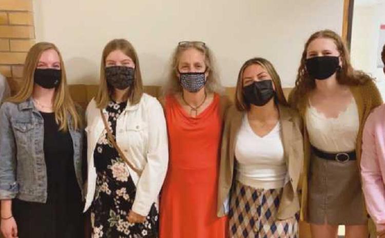 Students presented their idea for a new club during the school board meeting. Shown here with their English teacher Amy Farrar, middle, they are, from left, Will Kleeberger, Emma Olin, Abigail Ludwig, Bella Aromas, Lindsey Lazor and Owen Laib. Not pictured: Kacey Laumann, Olivia Achenbach and Leah Morris.
