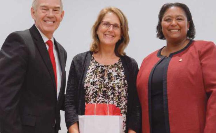Ohio Department of Higher Education Chancellor Randy Gardner, left, and Owens President Dione Somerville, right, present the Presidential Teaching Award to Owens nursing professor Julie Lohse, center.