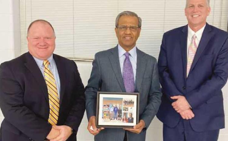 Dr. Razi Rafeeq, middle, received recognition for his work in the community. With him are at left, Eric Benington, president of the board of education, and Superintendent Tom Hosler.