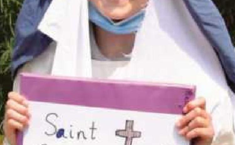 Sixth-graders research lives of saints