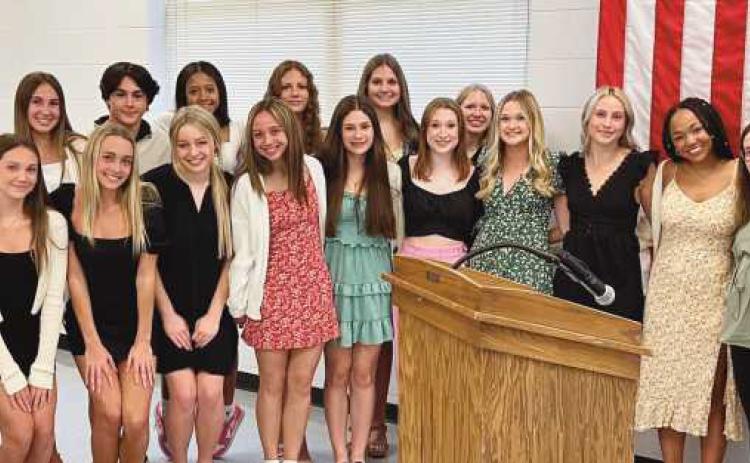 Board member Kelly Ewbank with members of the state-qualifying game day competitive cheerleading team.