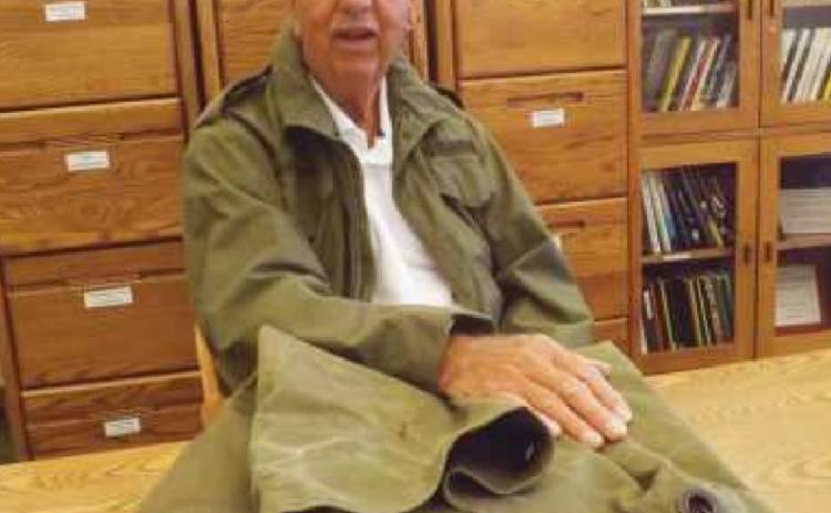 During his visit to the library, Mr. Armstrong wore his Army coat–which still fits–and brought along his faithful duffel bag.