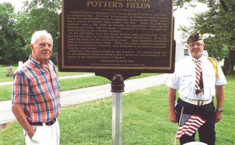 Gary Franks, left, and Craig Gauger with the Potter’s Field memorial.